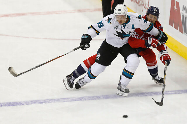 Oct 13, 2015; Washington, DC, USA; San Jose Sharks center Logan Couture (39) and Washington Capitals center Jay Beagle (83) battle for the puck in the first period at Verizon Center. Mandatory Credit: Geoff Burke-USA TODAY Sports